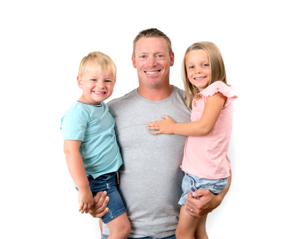 young happy and attractive american man holding his two children, a 7 years old lovely beautiful daughter and her little 3 years old brother in cheerful and loving family concept isolated on white - blond hair carrying little girls small imagens e fotografias de stock