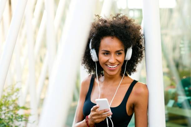 istock Smiling woman with headphones 918565194