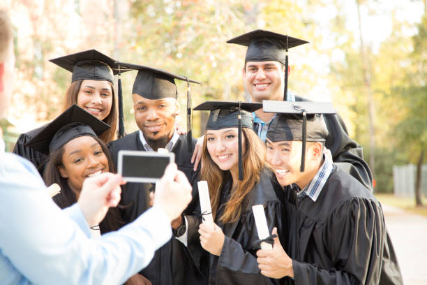 istock College students and father after graduation ceremony. 918565540