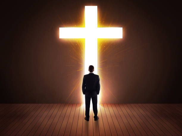 istock Man looking at bright cross sign 918565850