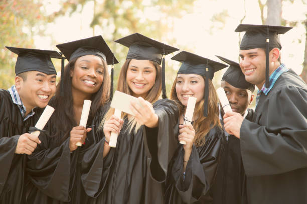 istock College student friends take selfie after graduation ceremony. 918565902