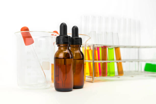 istock Stand with test tubes isolated on white. Several chemical solution in flask. Laboratory glassware 918569578