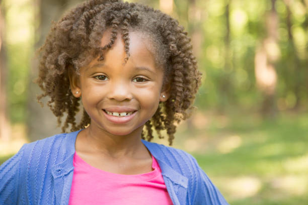 istock African descent, little girl outdoors in spring or summer. 918569604