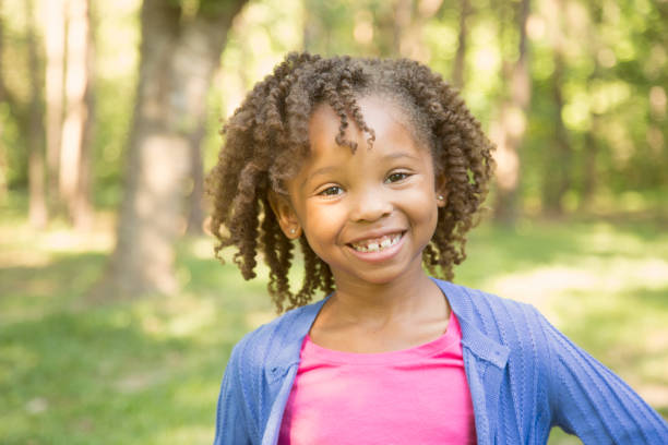 istock African descent, little girl outdoors in spring or summer. 918569778