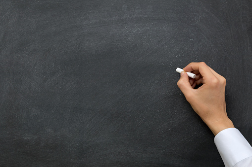 Hand writing on a blackboard