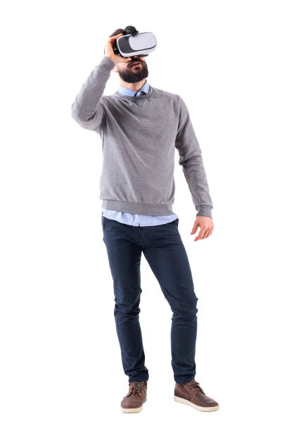 istock Young smart casual guy enjoying virtual reality glasses experience looking up 918572244