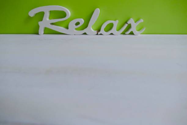 Wooden word Welcome on green background