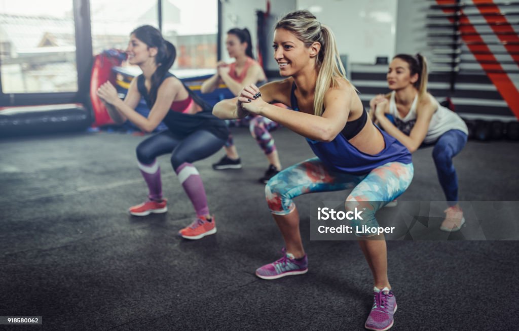 Group of athlete women exercising at the gym. Fitness women exercising at gym. Exercising Stock Photo