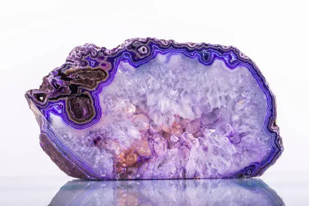 Photo of Purple agate slice on black background