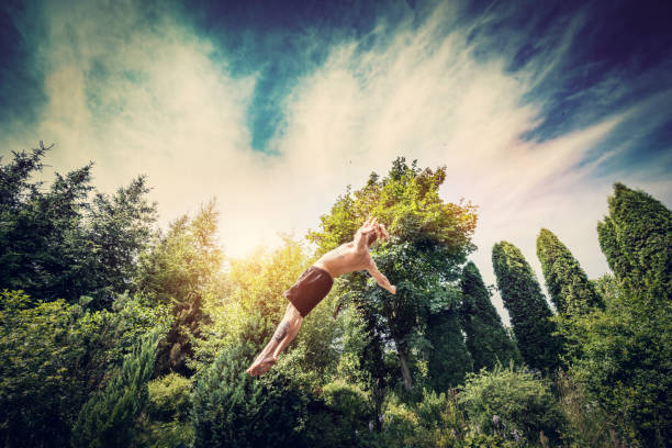 istock Young man jumping high in a garden. 918582866