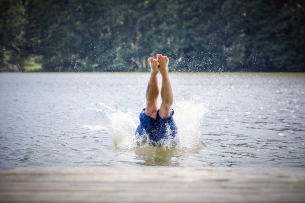 istock Young man diving into a lake. 918582918