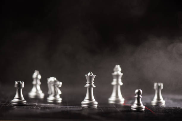 istock silver chess standing in the mist illustrate crisis and strategy concept 918586050
