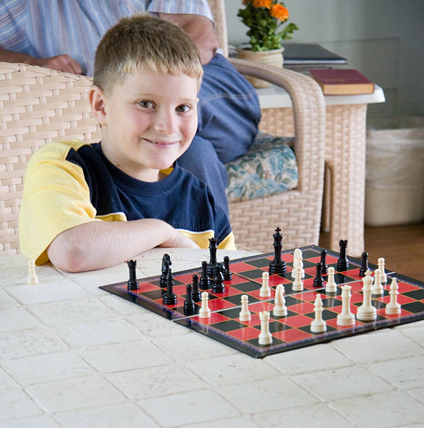 幸せな子供学習チェス - board game playing child family ストックフォトと画像