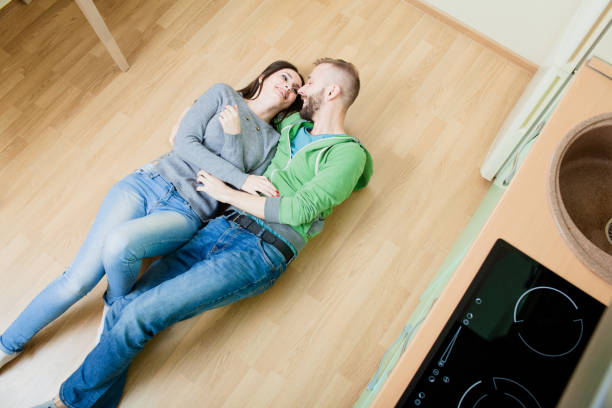 istock couple in the kitchen lying on the floor hugging 918587104