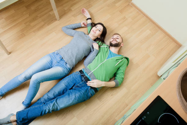 istock couple in the kitchen lying on the floor hugging 918587106