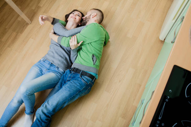 istock couple in the kitchen lying on the floor hugging 918587110
