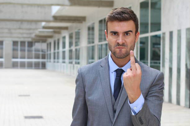 istock Insulting businessman throwing the middle finger 918590448