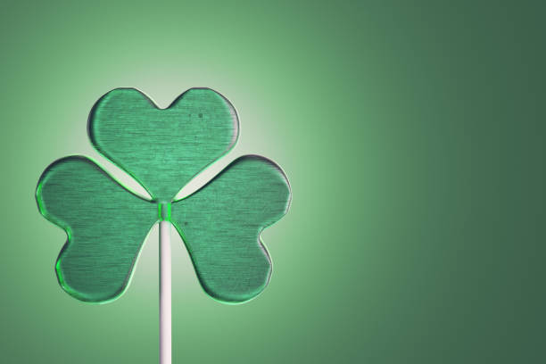 istock Lollipop candy in clover shape on green background 918591314