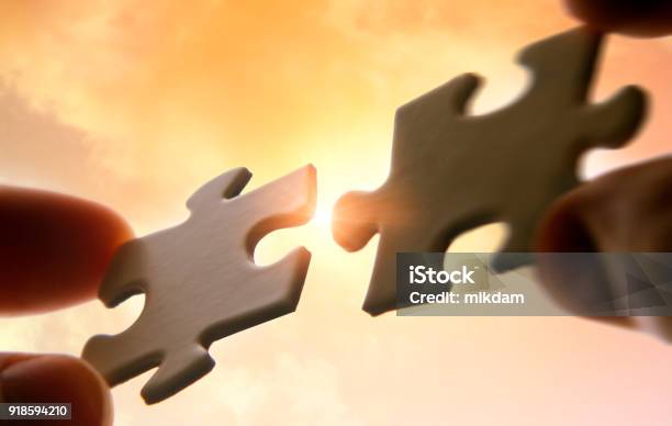 Hands Putting Puzzle Pieces Together Stock Photo - Download Image Now - Mergers and Acquisitions, Togetherness, Part Of