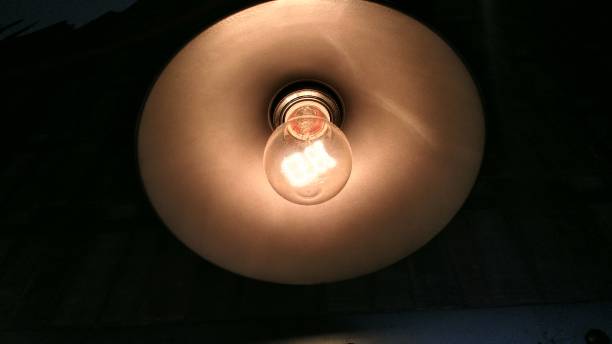 istock Vintage style of a ceiling yellow light close up. 918599546