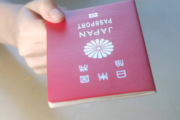 Persons hand holding a passport of Japan stock photo