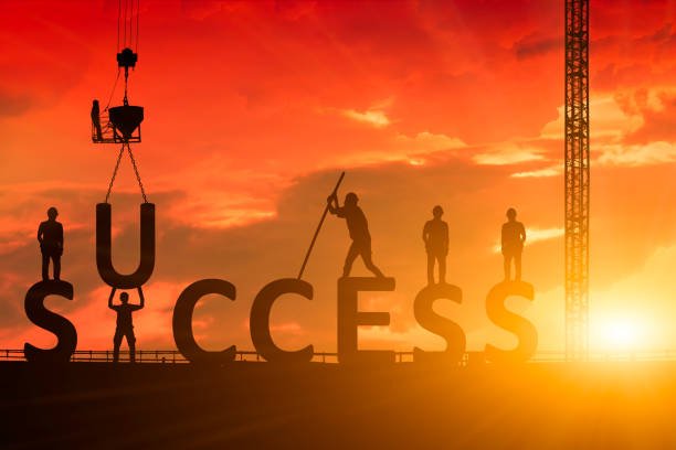 Silhouette of the success of the construction worker, the concept of success of the work is tired than to accomplish it, which has been difficult. stock photo