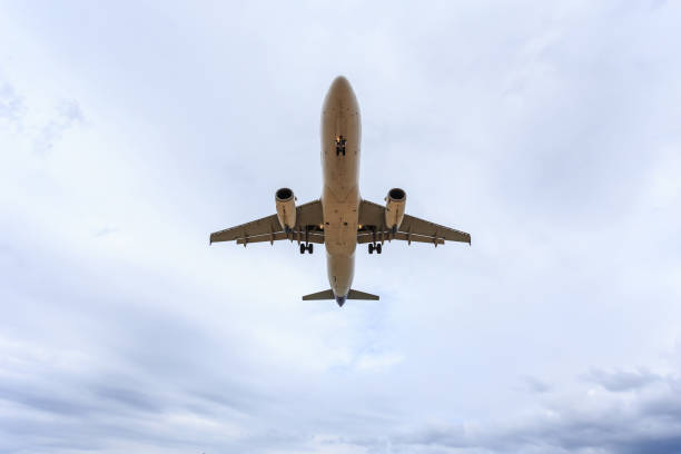 istock Airplane flying under blue sky and white cloud in Thailand 918618534