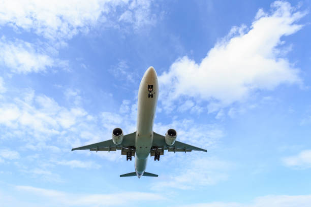 istock Airplane flying under blue sky and white cloud in Thailand 918618608