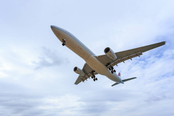istock Airplane flying under blue sky and white cloud in Thailand 918621524
