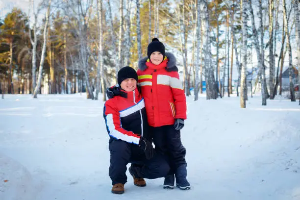 Photo of young father and his little son