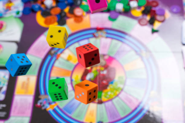 istock Several rolling color dice fall on a table with board game. Gaming moments in dynamics 918632546
