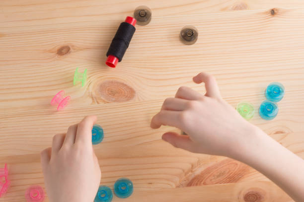 istock Multicolored plastic bobbin for sewing machine