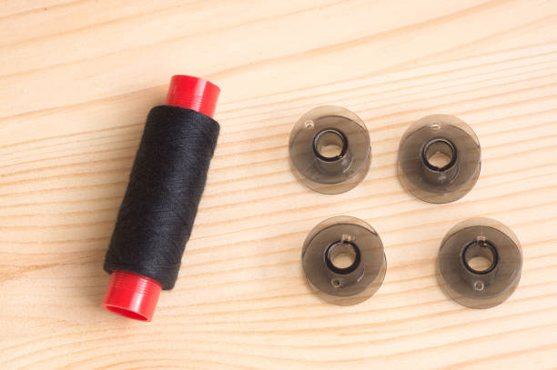 istock Black plastic bobbin for sewing machine