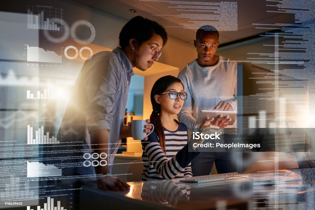 What if we upload this software Shot of computer programmers looking through data in the office Business Stock Photo