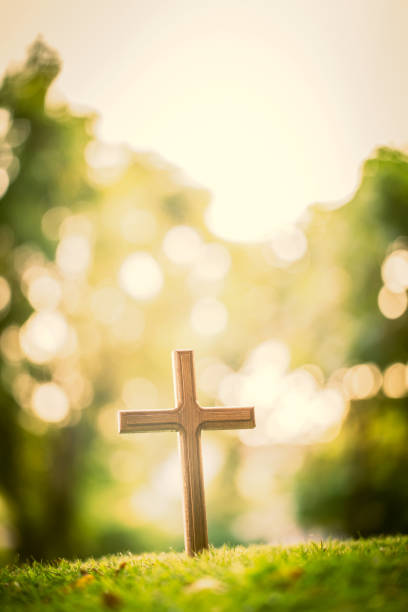 istock The cross standing on meadow sunset and bokeh background. 918639842