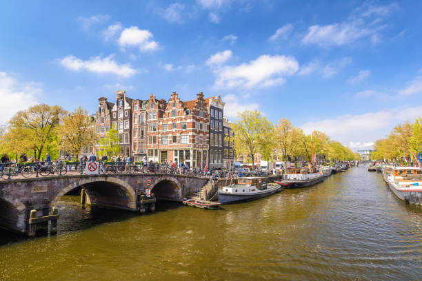 istock Amsterdam city skyline at canal waterfront, Amsterdam, Netherlands 918640152