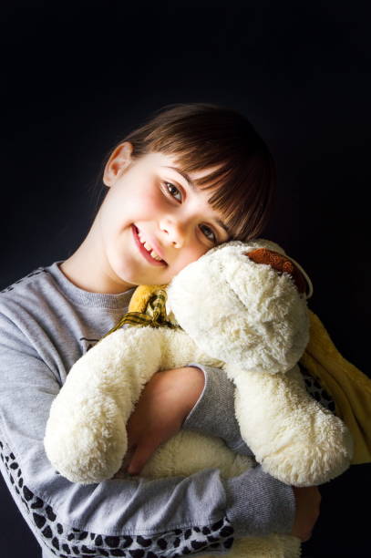 istock Cute little girl hugging her toy 918642492