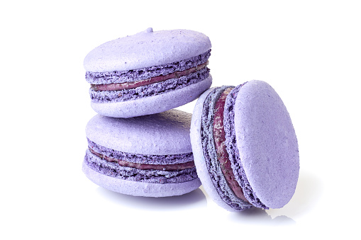 Three violet macarons isolated on white background