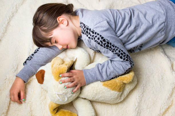 istock Girl taking a nap hugging her toy 918642884