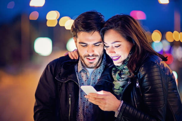 istock Couple is texting on the bridge in the night 918643096