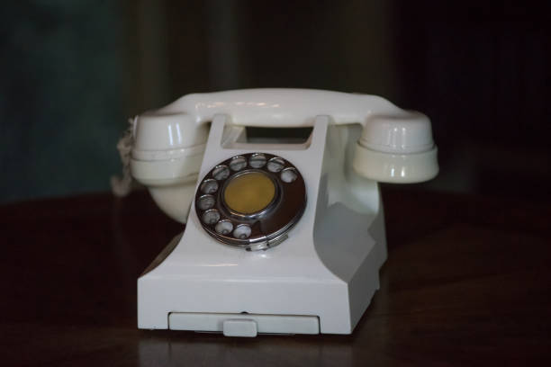 istock Vintage phone light beige with dialer on dark background. 918645748