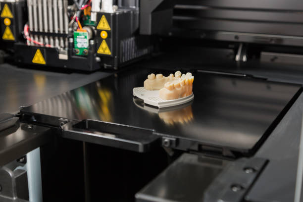 3D Printer With Finished 3D Printed Dental Implant Bridge Open 3D Printer With Finished 3D Printed Dental Implant Bridge. 3d printing lab stock pictures, royalty-free photos & images