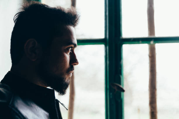 istock Man looking out of the window 918646326
