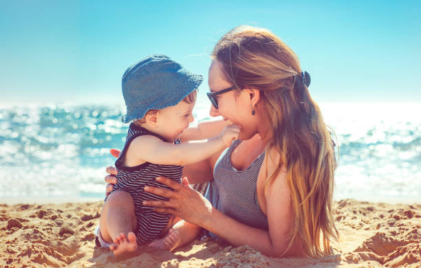 istock Mother and son playing on the beach 918646678