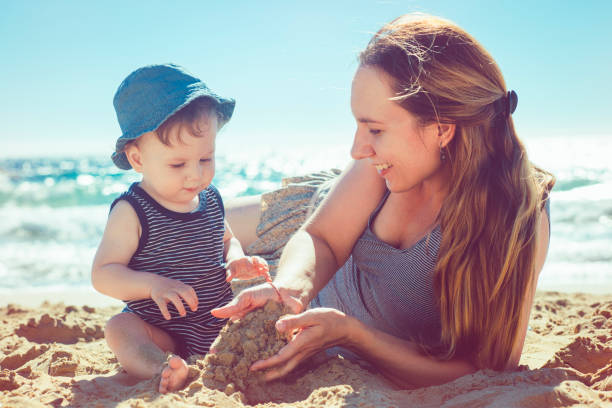istock Mother and son playing on the beach 918646682
