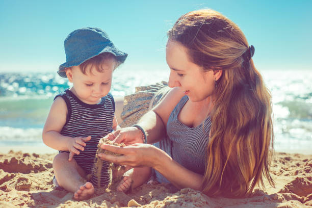 istock Mother and son playing on the beach 918646692