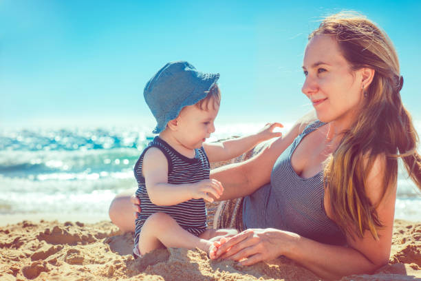 istock Mother and son playing on the beach 918646710