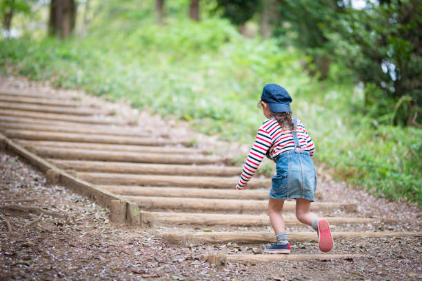 istock Little girl walking in the forest 918648832