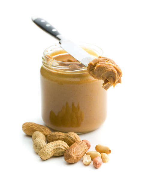 Creamy peanut butter Creamy peanut butter and peanuts  isolated on white background. Spreads peanut butter in the jar. peanutbutter stock pictures, royalty-free photos & images