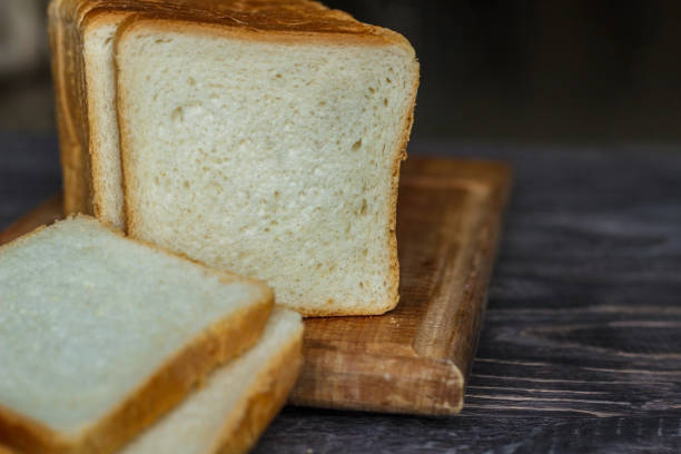 istock White bread sliced with slices on a wooden background close-up. 918653724